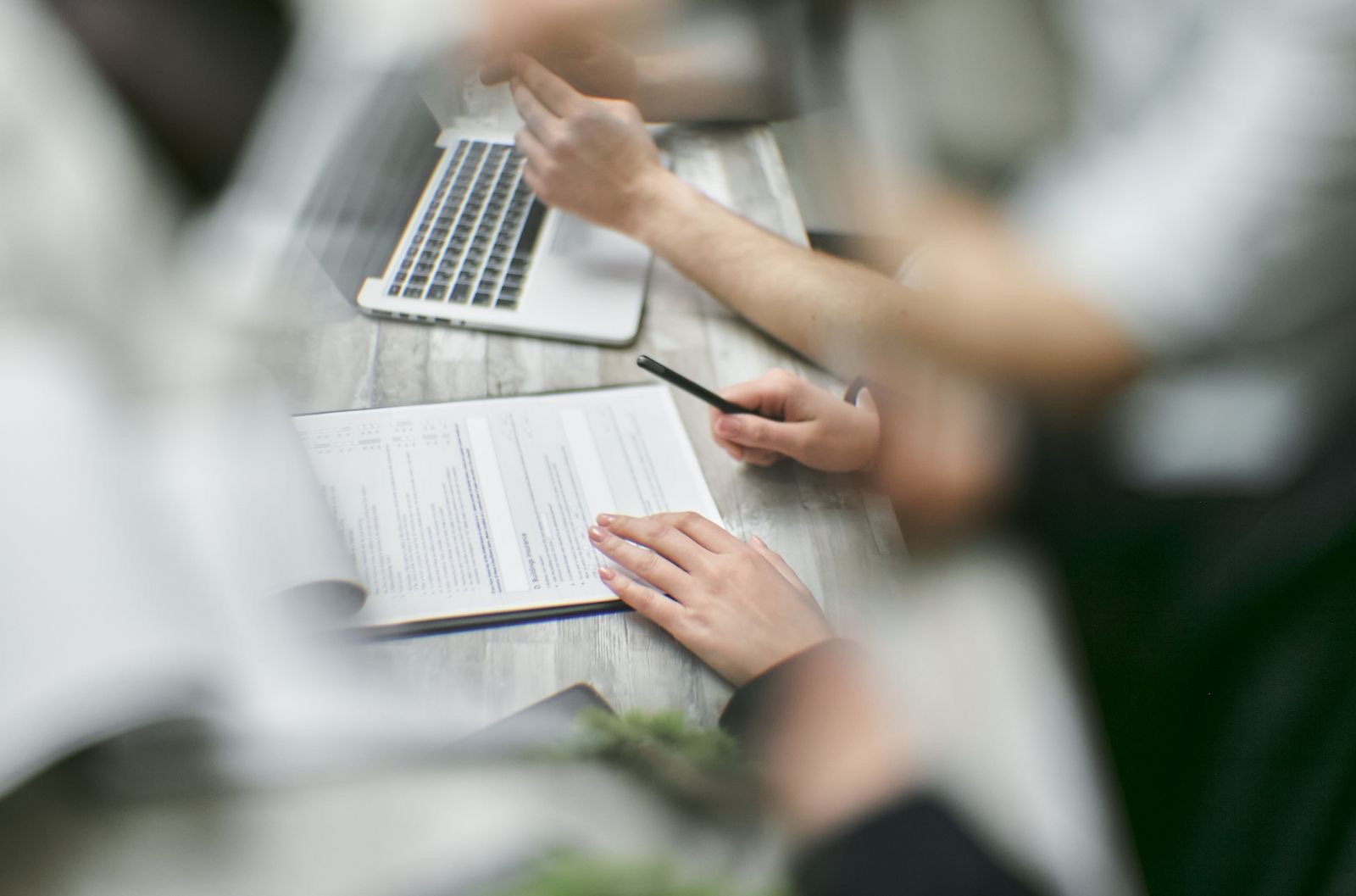Two professionals reviewing documents at a desk