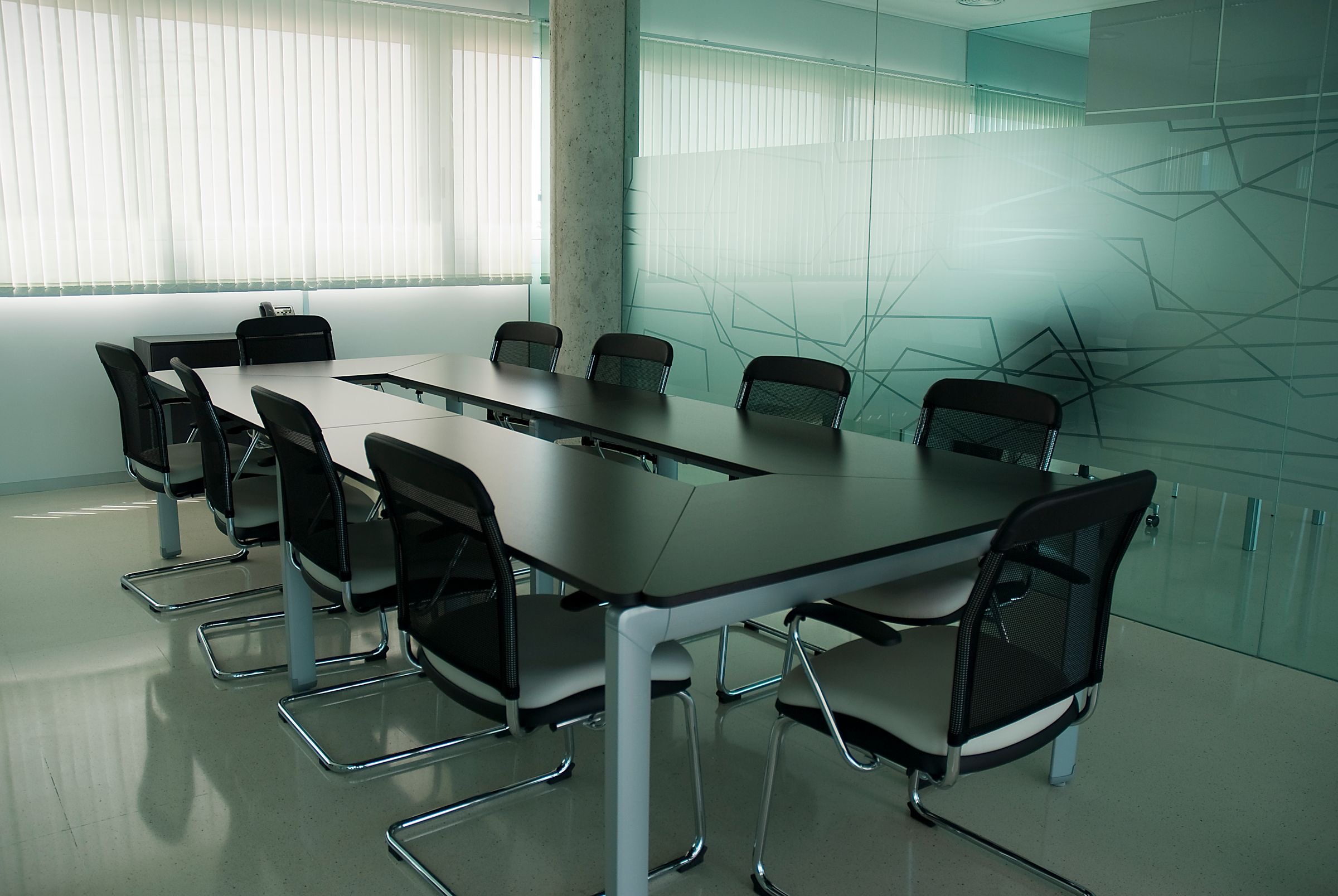 Executives seated around a boardroom table reviewing documents