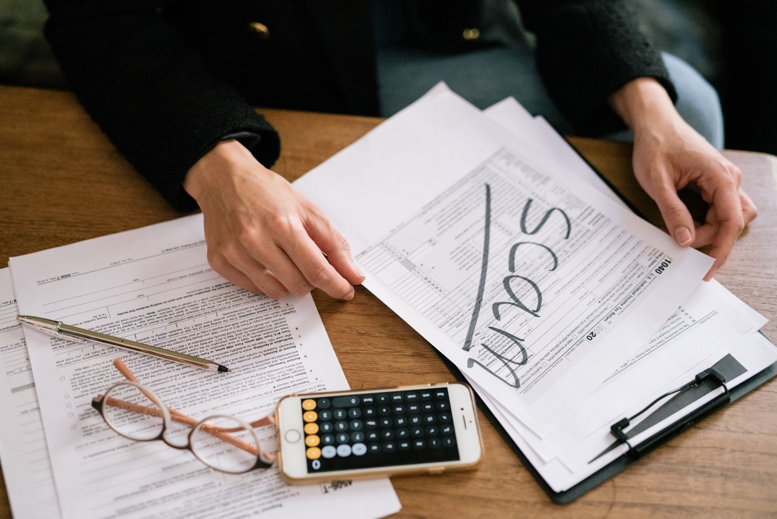 A desk with tax documents and a calculator